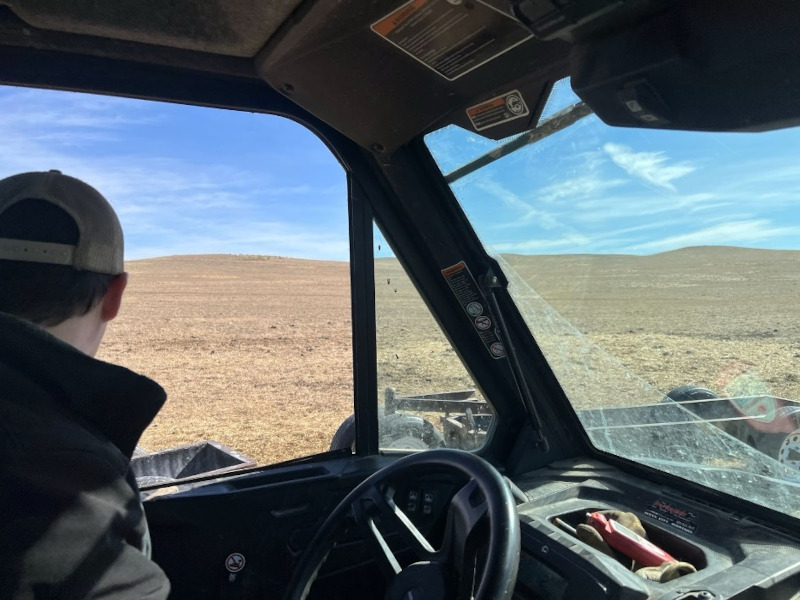 A farmer in his truck looking at the field